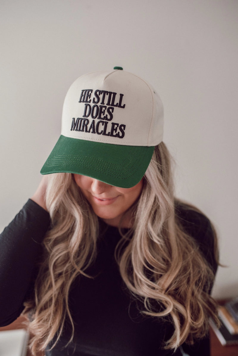 He Still Does Miracles Trucker Hat