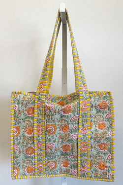 Floral patterned tote bag with yellow trim on a white background

