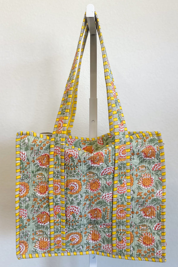 Floral patterned tote bag with yellow trim on a white background
